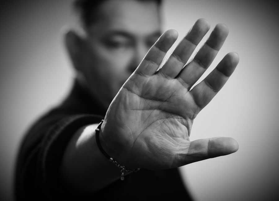 Close-up of a raised hand in a stop gesture